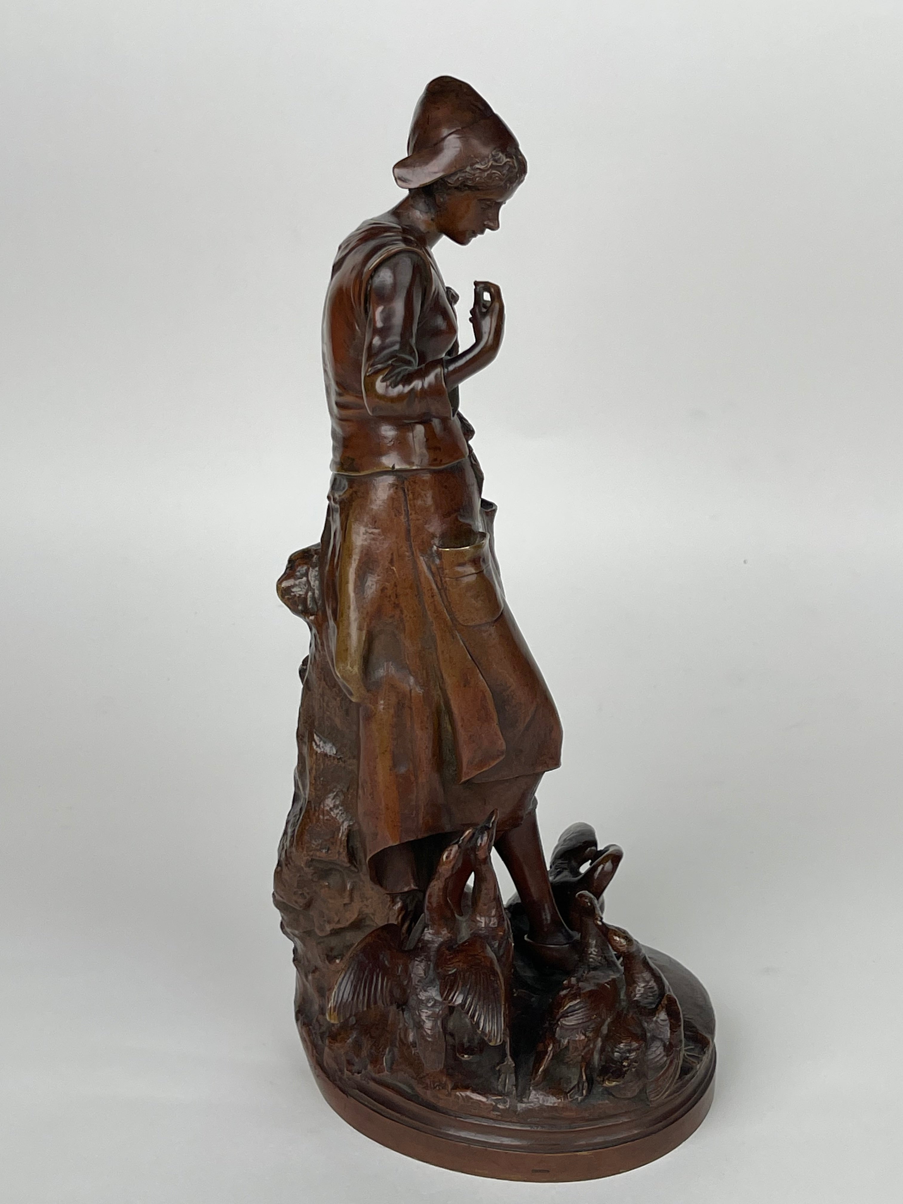 A Patinated Bronze Sculpture Of A Standing Lady Feeding Ducks By Lalouette