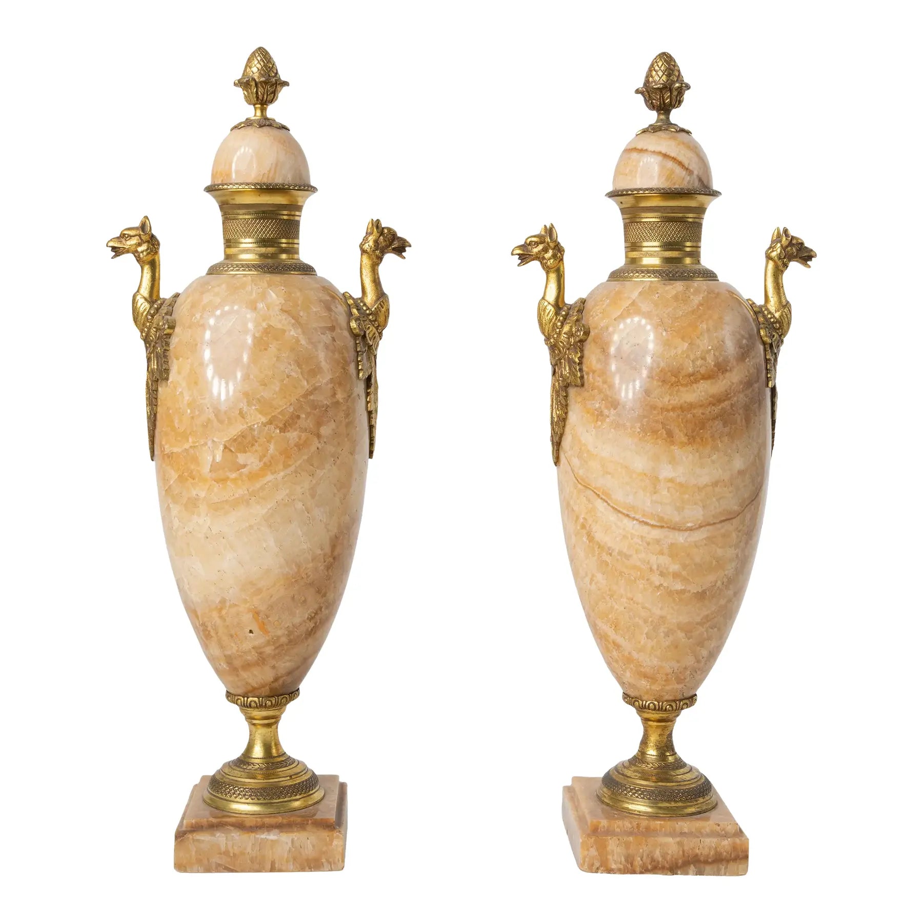 Pair of ornate urns with marble bodies and gold accents on a white background